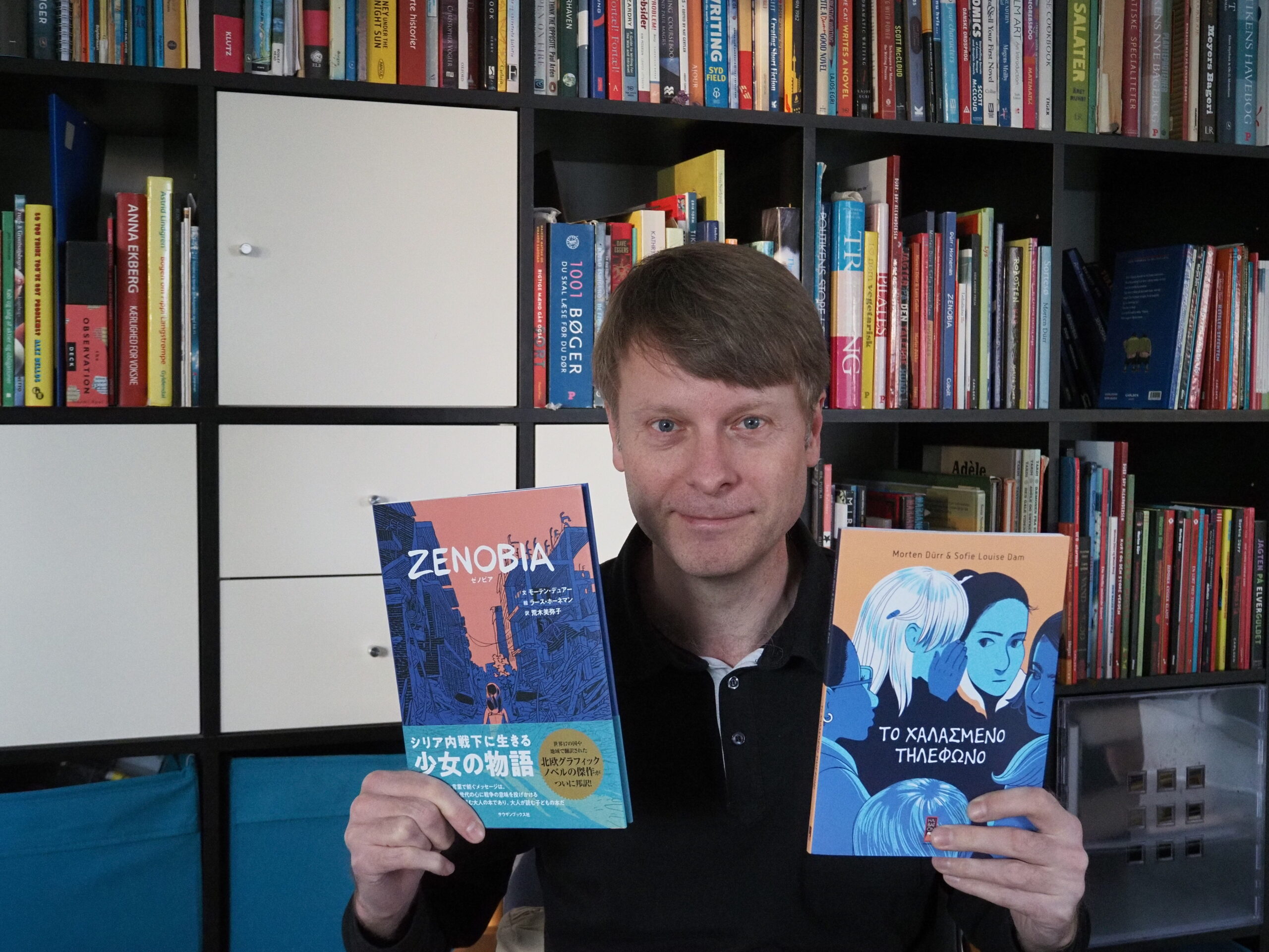 Morten Dürr with the Japanese edition of “Zenobia” and the Greek edition of “The Whispers Game.”